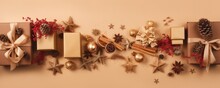 Banner Top View Christmas Decoration Composition On Light Gold Background. Golden Gift Box, Fir Branches, Cones, Stars, Christmas Cookies, Cinnamon. Ai Generative.