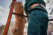 Low angle view of arborist cuts the trunk of an emergency tree with a chainsaw.