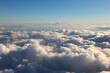 Fluffy clouds aerial view. White cumulus clouds sky view from aircraft window.