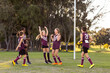 © Austockphoto - happy kids on football team near goal post