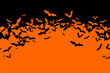 © Yulia Ogneva - Halloween banner with black bats on the orange background. Illustration with text.