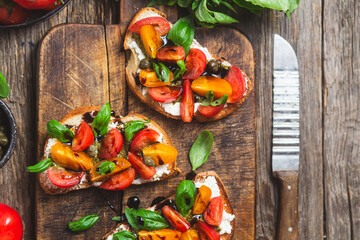 Wall Mural - Sandwich with tomatoes, pesto and balsamic sauce on a wooden board