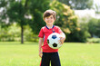© Louis-Paul Photo - Young soccer player having fun on a field with ball