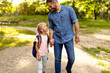 © Prostock-studio - First day at school. Happy father leading his little child school girl in first grade, holding hands with daughter