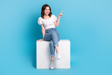 Sticker - Full length photo of pretty cute lady wear white blouse pointing finger empty space isolated blue color background