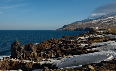 Wall Mural - Russia. Far East, Kuril Islands. Very hard and sharp basalt rocks along the coast of the Sea of Okhotsk on the island of Iturup.