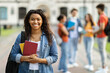 © Prostock-studio - Loans for education concept. Portrait of happy black female student posing outdoors
