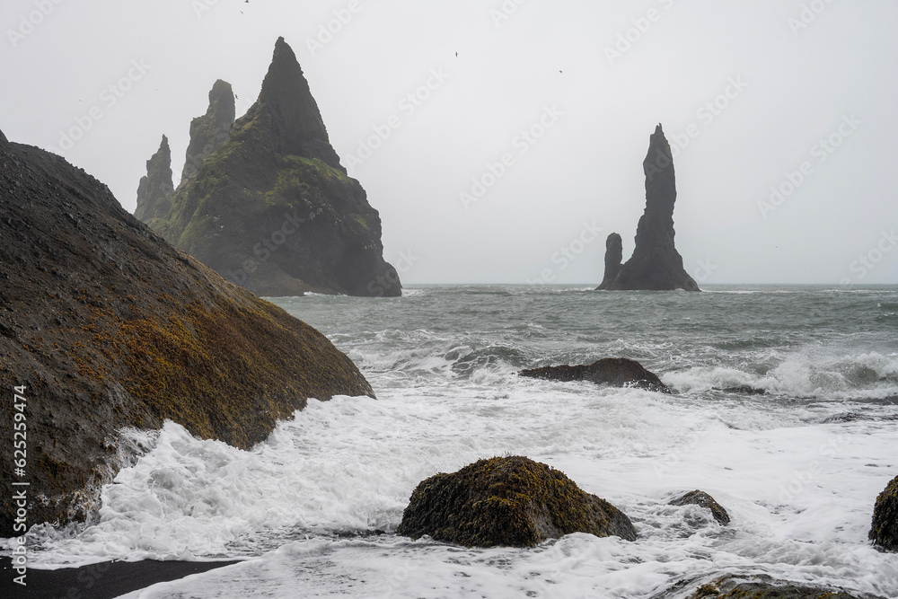 black sand beach Reynisfjara and Reynisdrangar - basalt sea stacks ...