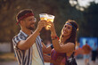 © Drazen - Cheerful couple has fun while toasting with beer on music concert.