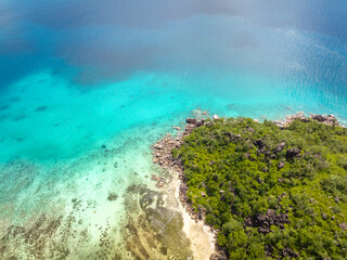 Wall Mural - Praslin Seychelles tropical island with withe beaches and palm trees. Aerial view of tropical paradise bay with granite stones and turquoise crystal clear waters of Indian Ocean