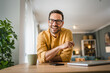 © Miljan Živković - One adult man with eyeglasses stand at home happy smile