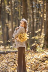 Wall Mural - Portrait of a young woman in autumn forest