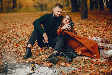 Wall Mural - Elegant couple spend time in a autumn park