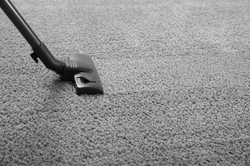 Canvas Print - Removing dirt from grey carpet with modern vacuum cleaner. Space for text