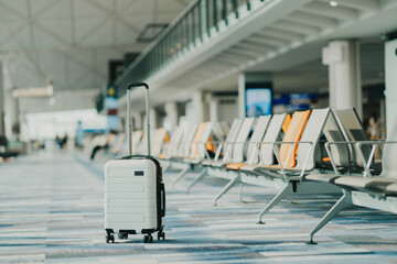 Wall Mural - The suitcases in an empty airport hall, traveler cases in the departure airport terminal waiting for the area, vacation concept, blank space for text message or design