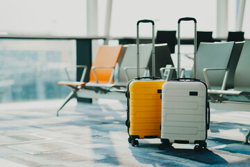 Wall Mural - Two suitcases in an empty airport hall, traveler cases in the departure airport terminal waiting for the area, vacation concept, blank space for text message or design