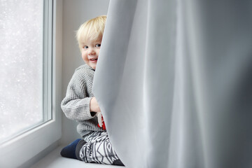 Toddler boy playing at home