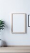 © Desain - Blank picture frame mockup on white wall. Modern living room design