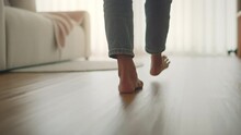 B Roll - Closeup Foot Of Young Woman Walking On Wooden Floor At Home