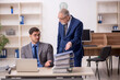 © Elnur - Two male colleagues working in the office