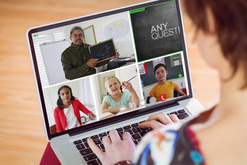 Poster - Caucasian girl looking at teacher and students over video call on laptop screen during online class