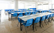 © xy - Clean school cafeteria with empty seats and tables