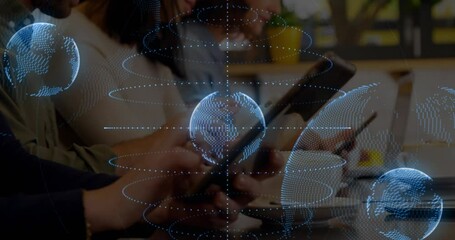 Sticker - Animation of globes and spiral pattern, cropped hands of caucasian woman using digital tablet