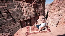 Tourist Sitting Atop High View Point Near The Treasury Petra Jordan