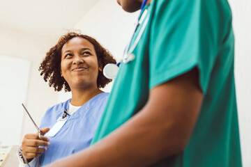 Skillful general student practitioners discussing human health with senior doctor, having conversation with experienced professional medical worker, in hospital