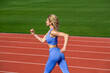 © Yevhen - Fitness woman on stadium. Young fitness woman runner running on stadium track. Woman in sportswear jogging on stadium. Female jogger runner running outdoors. Active lifestyle concept, runner