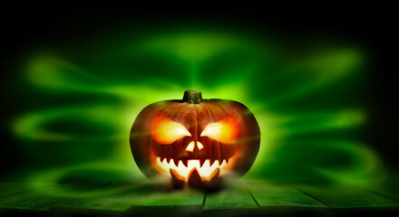 Wall Mural - a spooky halloween pumpkin, jack o lantern, with an evil spinning green aura glow against a dark bac