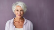 © Robert Kneschke - French woman in 50s, white hair, lilac background