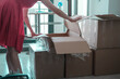© Ela - young woman packing or unpacking kitchen stuff from the carton boxes after before moving, SSTK Home