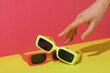 © Atlas - A pair of sunglasses on a bright, colorful background