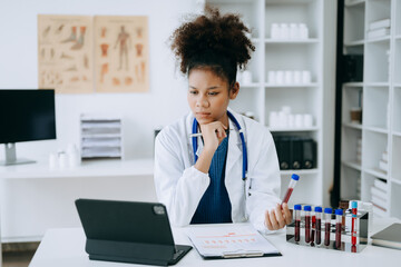 African doctor or consultant sitting at a desk writing sick note, surgery planning and prescription.and clinical report test results in office