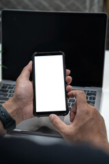 Man holding smartphone with blank screen, close-up of hands. Space for text.