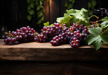 Vineyard Grapes On A Wooden Table With Nature Blurred Background. Fresh Grapes On Wooden Table Overlooking Vineyard At Sunset