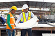 © NVB Stocker - Professional Engineer Team working. Young architect Engineering and asian worker in safety hardhat and  looking at blueprint at industrial Heavy Manufacturing Factory. Prefabricated concrete walls
