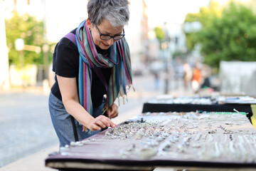 Poster - Mature female shopper at a flea market.