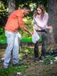 © guruXOX - Young couple collect garbage thrown in nature park. Protection, maintenance and preserve of the eco green environmental. Trash Impacts the environment