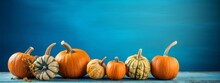 Happy Fall Halloween Autumn Holiday Thanksgiving Banner Greeting Card - Pumpkins On Rustic Wooden Table With Blue Wall Background  (Generative Ai)