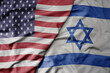 big waving colorful flag of united states of america and national flag of israel .