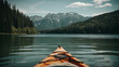 kayak on lake with mountains and forests in background.