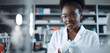 © AIproduction - Young african female scientific in working in lab