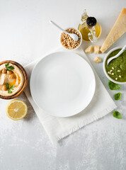 Wall Mural - summer dishes, pesto and hummus , empty plate. summer vibe