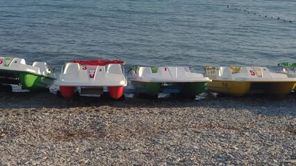 Canvas Print - Water catamarans stand on the seashore.