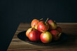 apples in dish on a wooden table