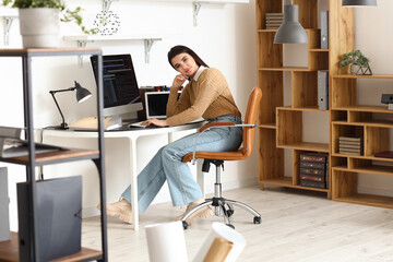 Poster - Young female programmer working in office