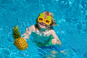 Wall Mural - Child playing in the swimming pool. Summer kids activity.