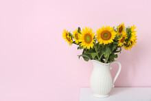 Vase With Sunflowers On Shelf Near Pink Wall